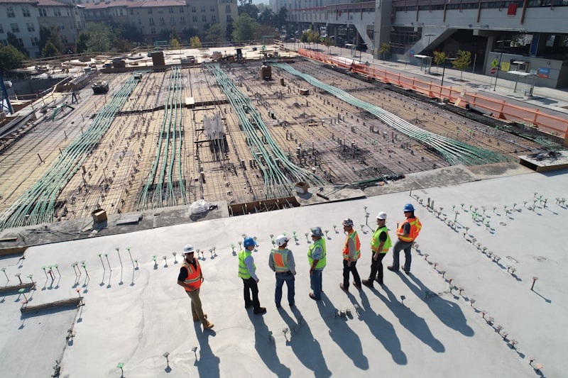 Total InCharge construction team reviewing electrical plans on a commercial EV charging project site